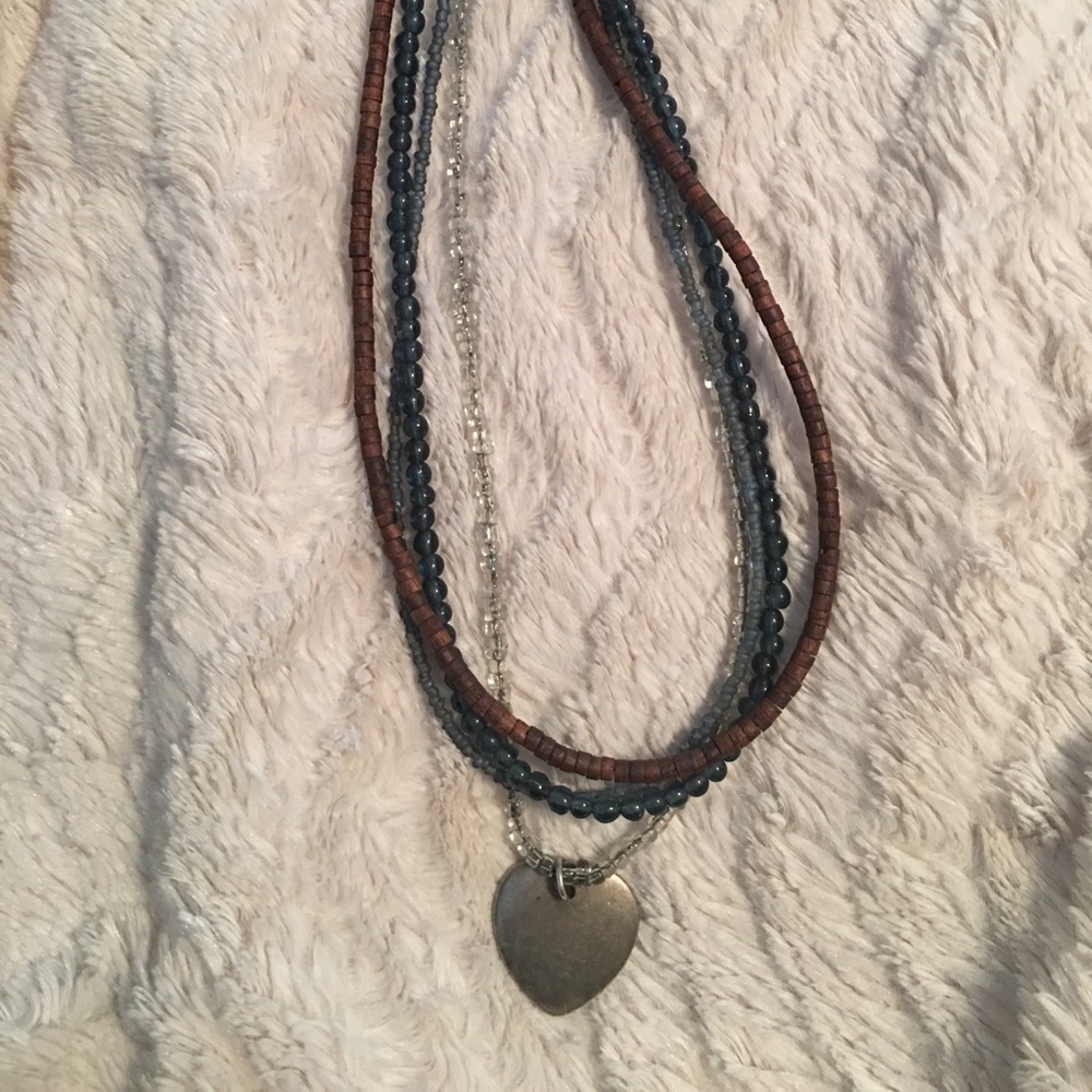 Beaded necklace with silver heart charm.
